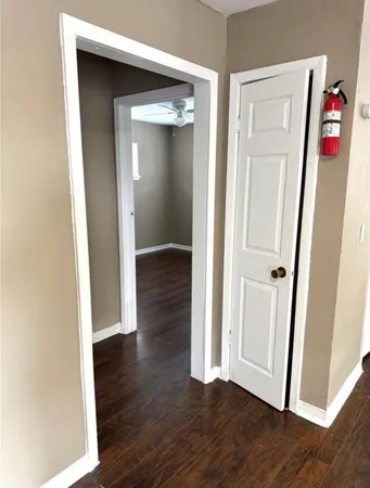 an empty room with wooden floor and closet