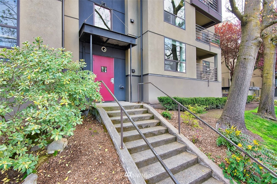 7323 Sand Point Way Northeast, Unit 106 Seattle, WA 98115 - Photo 2 of 21 a view of a pathway along the building