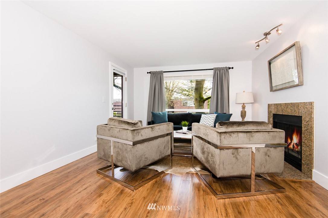 7323 Sand Point Way Northeast, Unit 106 Seattle, WA 98115 - Photo 11 of 21 a living room with furniture and a fireplace