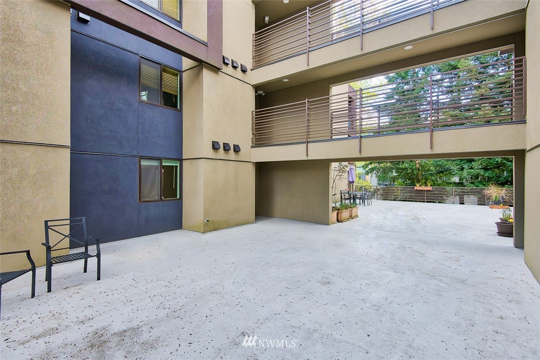 7323 Sand Point Way Northeast, Unit 106 Seattle, WA 98115 - Photo 6 of 21 a view of a house with a yard