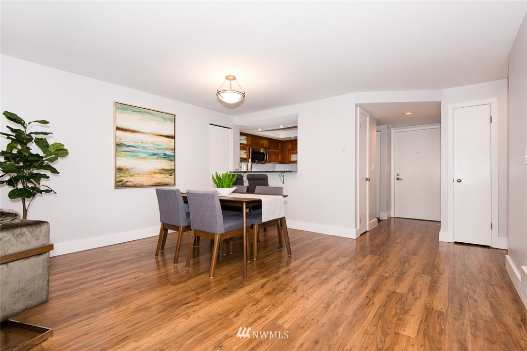 7323 Sand Point Way Northeast, Unit 106 Seattle, WA 98115 - Photo 7 of 21 a view of a dining room with furniture and wooden floor