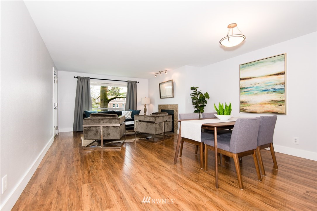 7323 Sand Point Way Northeast, Unit 106 Seattle, WA 98115 - Photo 9 of 21 a living room with furniture and a wooden floor