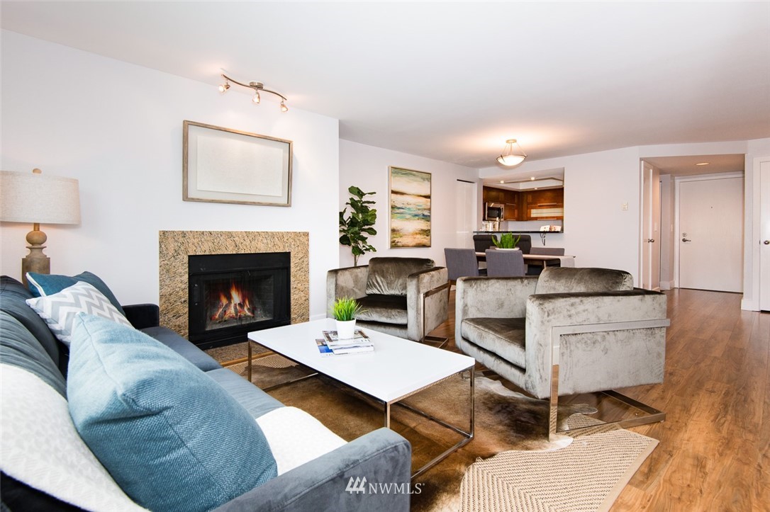 7323 Sand Point Way Northeast, Unit 106 Seattle, WA 98115 - Photo 10 of 21 a living room with furniture and a fireplace