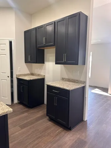 a kitchen with stainless steel appliances granite countertop wooden cabinets and granite counter tops