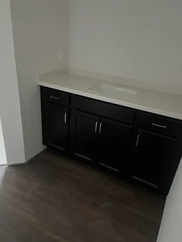 a kitchen with a sink and cabinets