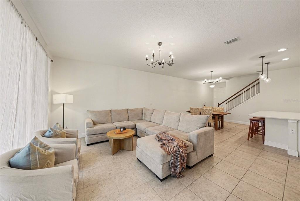 10210 Newel Valley Loop Riverview, FL 33569 - Photo 9 of 30 a living room with furniture and a chandelier