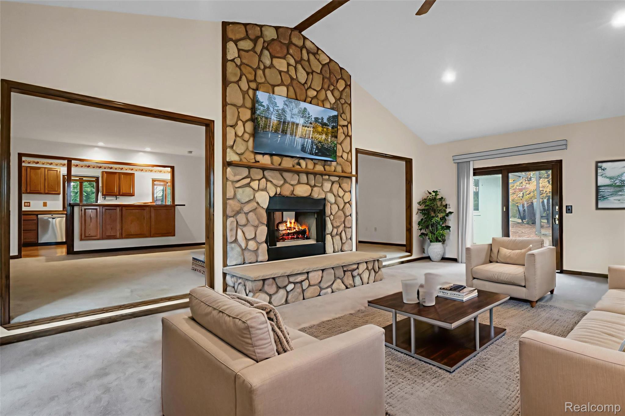 1431 East Commerce Road Commerce Township, MI 48382 - Photo 6 of 27 Living room featuring a stone fireplace, carpet floors, ceiling fan, recessed lighting, and high vaulted ceiling