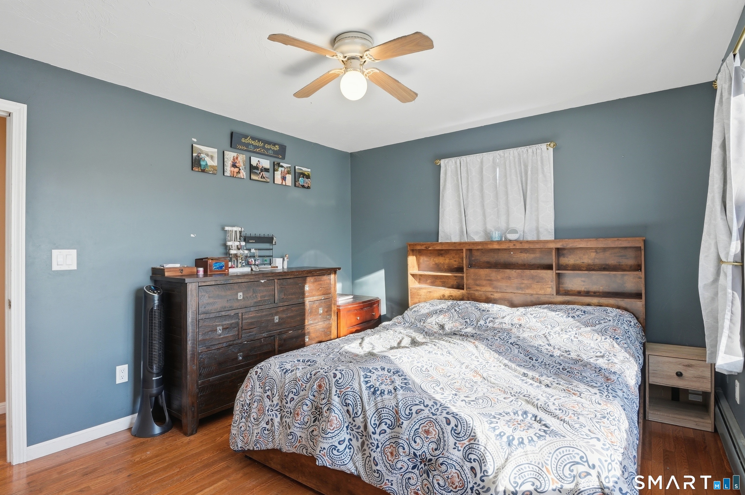 17 Vine Street Putnam, CT 06260 - Photo 17 of 35 a bedroom with a bed and wooden floor