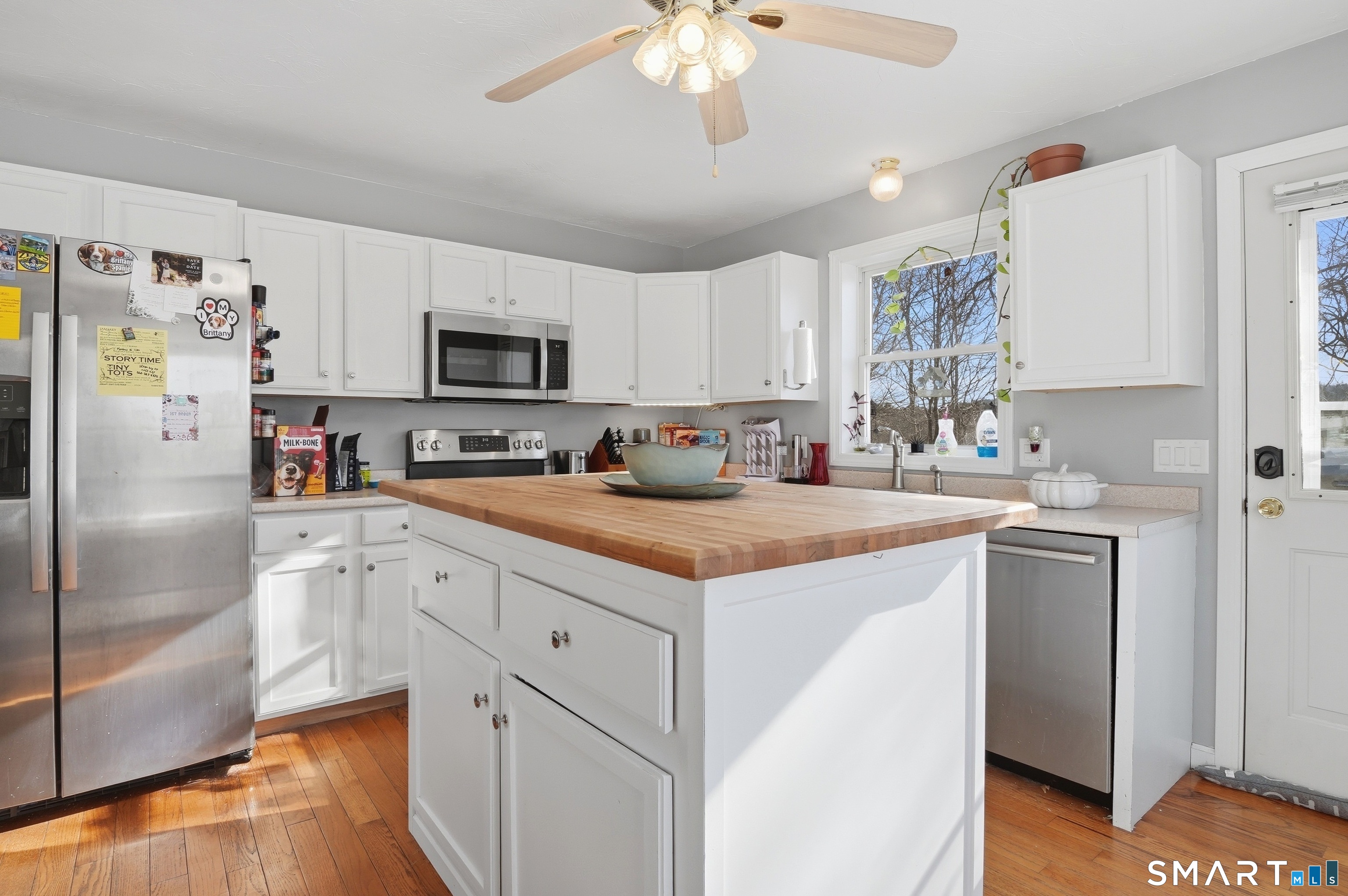17 Vine Street Putnam, CT 06260 - Photo 3 of 35 a kitchen with a refrigerator a microwave a sink and cabinets