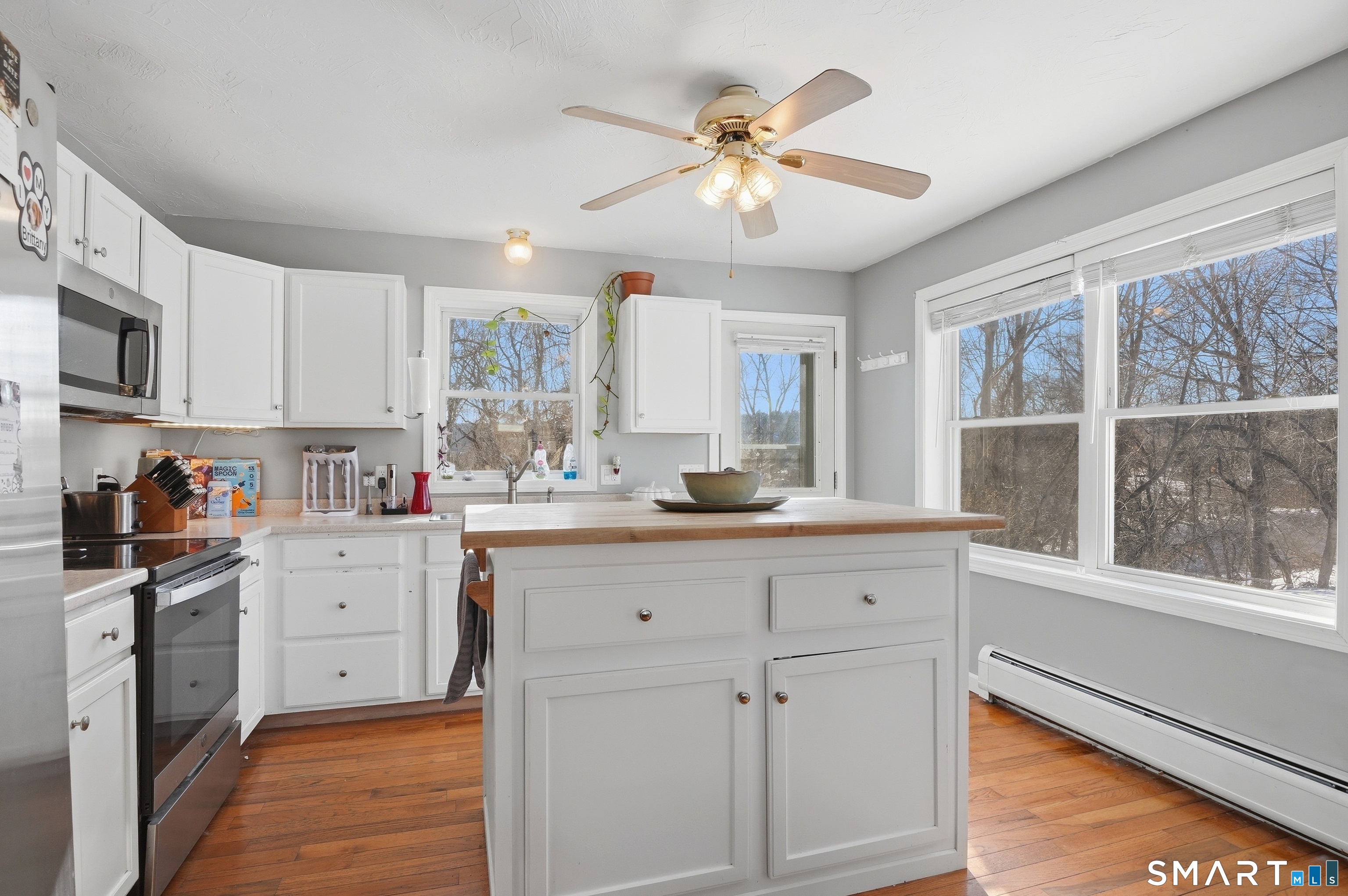 17 Vine Street Putnam, CT 06260 - Photo 4 of 35 a kitchen with white cabinets and wooden floors