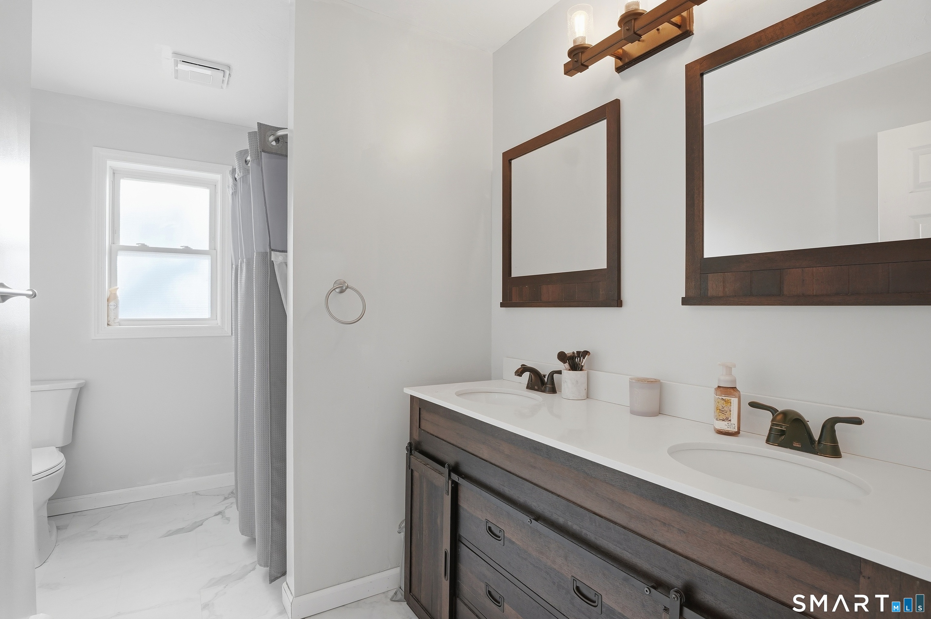 17 Vine Street Putnam, CT 06260 - Photo 10 of 35 a bathroom with a sink a toilet and mirror