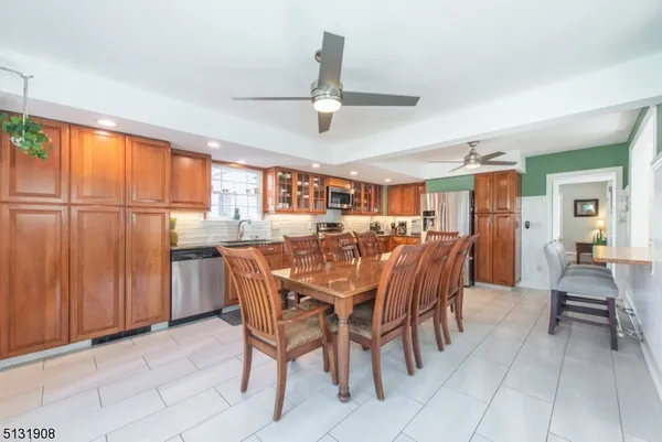 a dining room with furniture a chandelier and window