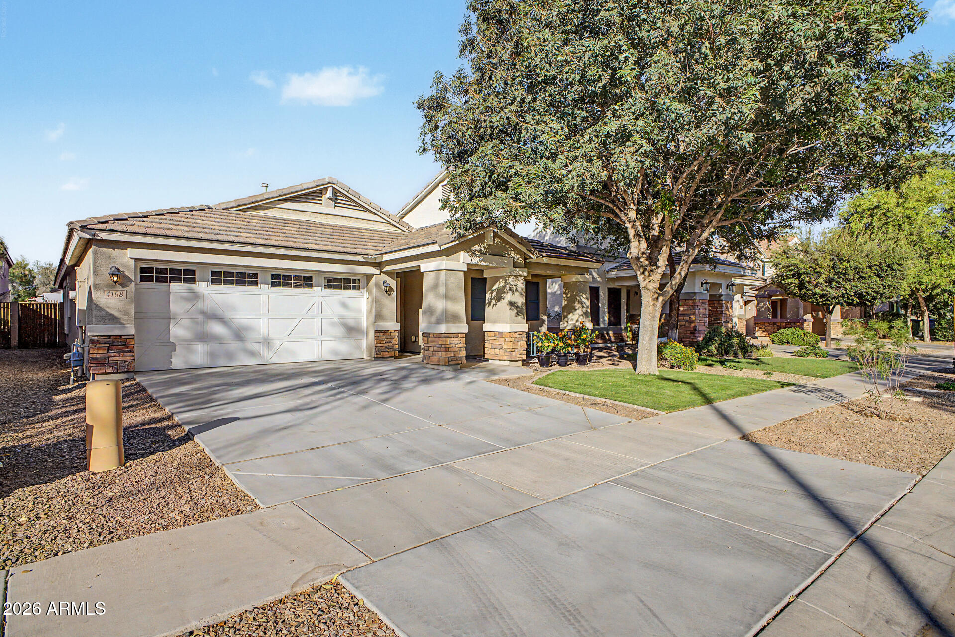 4168 East Sandy Way Gilbert, AZ 85297 - Photo 2 of 47 a front view of a house with a yard
