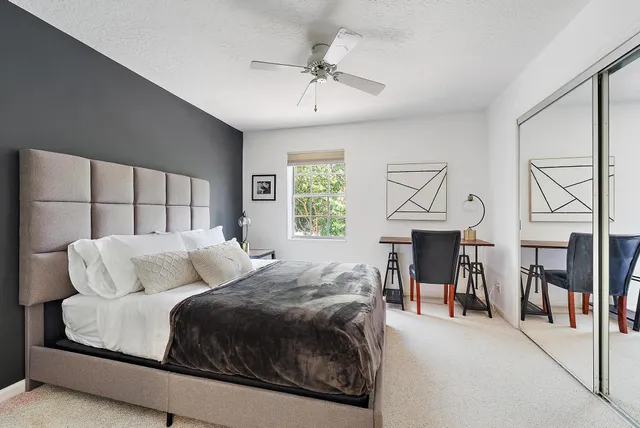 a living room with a bed furniture and a chandelier