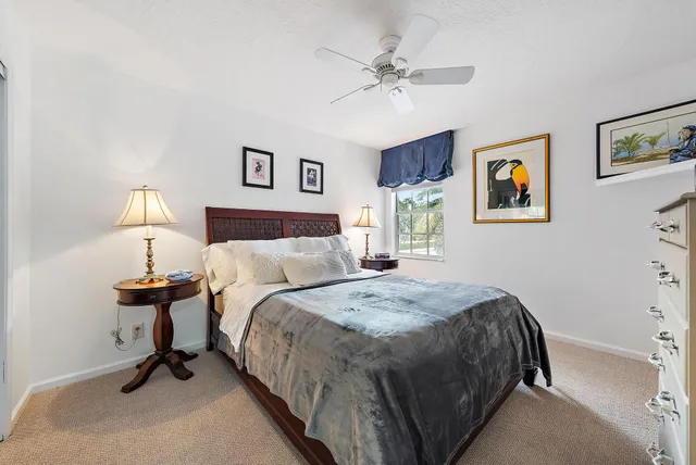 a spacious bedroom with a bed and a chandelier
