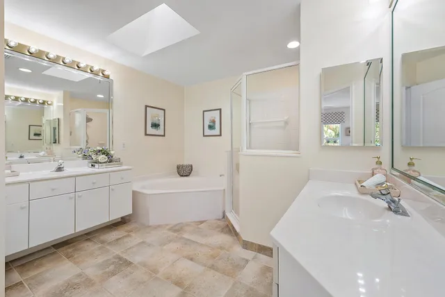 a bathroom with a sink a tub and a mirror