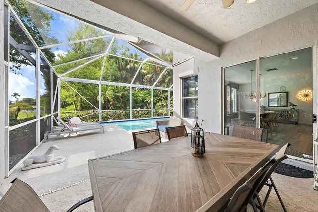 a dining room with furniture and a large window