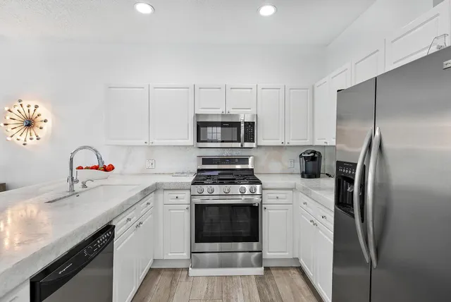 a kitchen with a stove sink and refrigerator