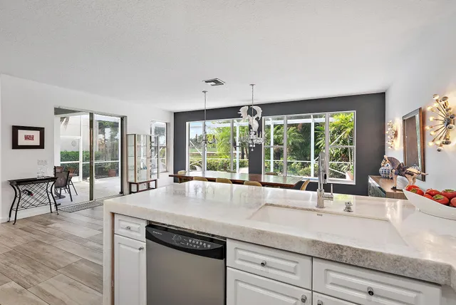 a living room with furniture and large windows