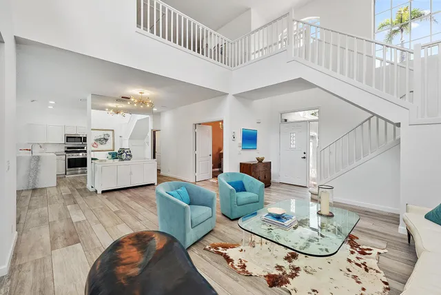 a living room with furniture and kitchen view