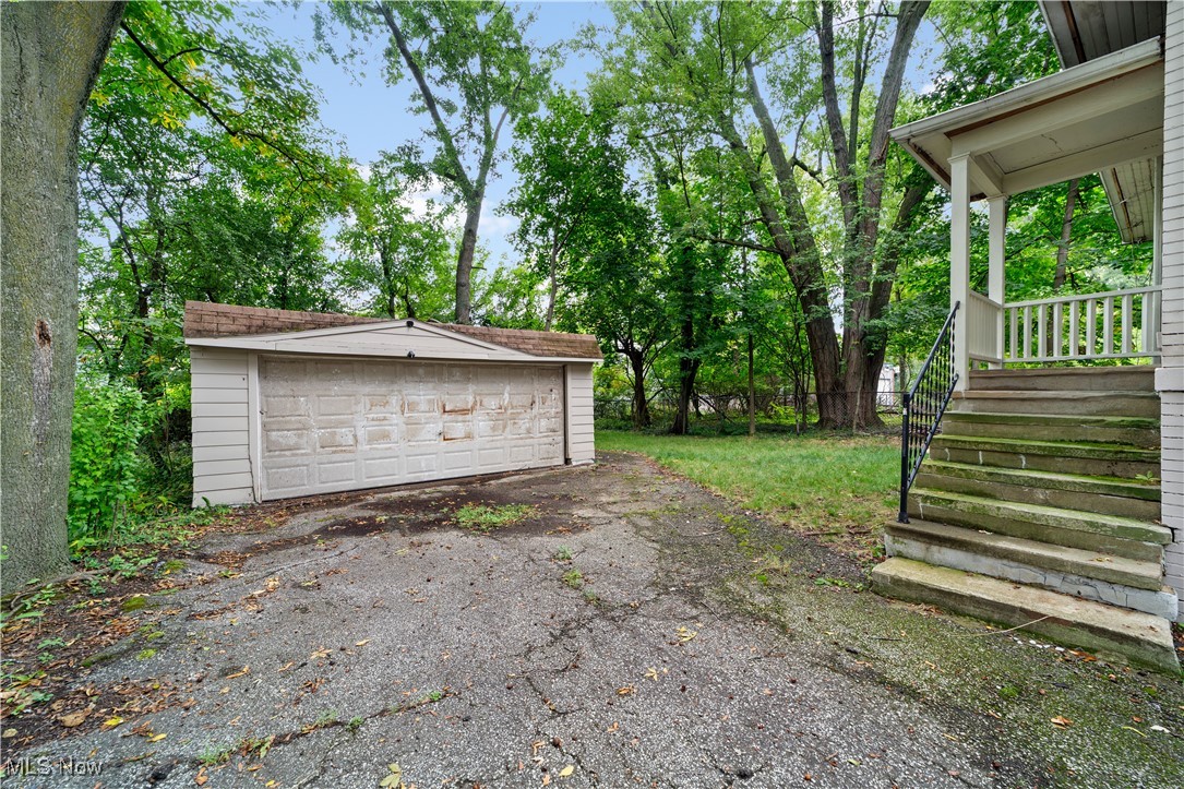 3165 Oak Road Cleveland, OH 44118 - Photo 28 of 30 View of yard featuring an outbuilding, a garage, view of scattered trees, and a porch