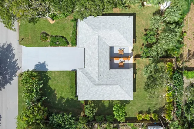 an aerial view of a house with a yard