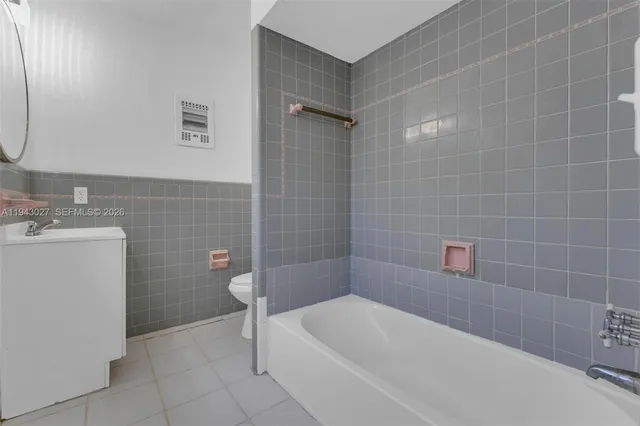 a bathroom with a sink a toilet and bathtub