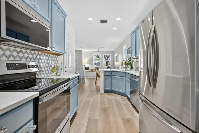 a kitchen with a refrigerator stove and sink
