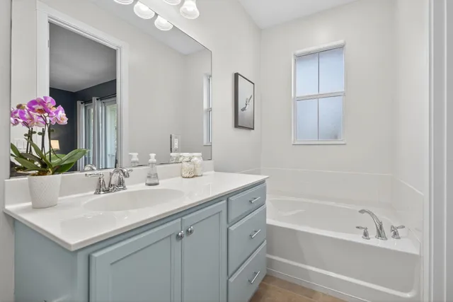 a bathroom with a granite countertop sink a toilet and a mirror