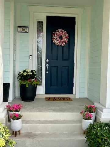 a view of a entryway and flowers