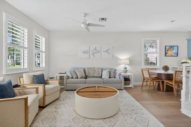 a living room with furniture a rug and a window