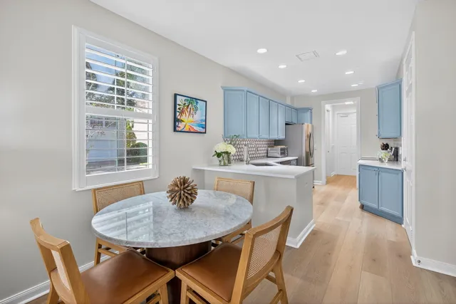 a living room with furniture wooden floor and dining table