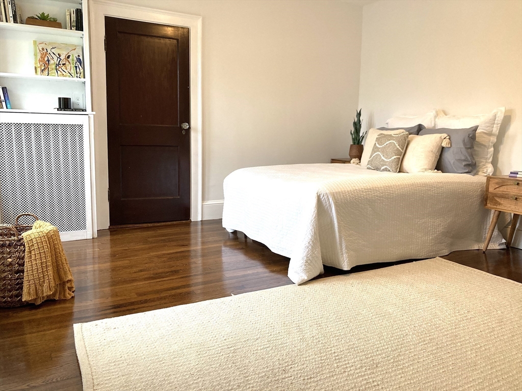 131 Damon Road Medford, MA 02155 - Photo 11 of 22 a bedroom with a bed and wooden floor