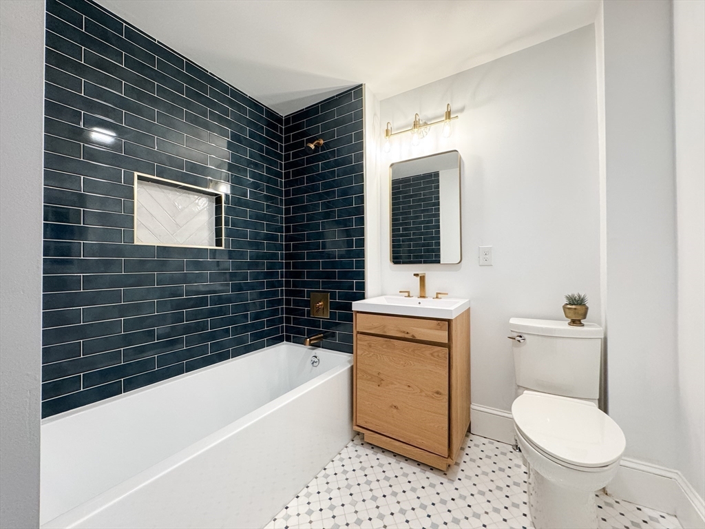 131 Damon Road Medford, MA 02155 - Photo 12 of 22 a bathroom with a toilet sink and mirror