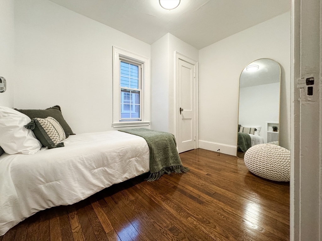 131 Damon Road Medford, MA 02155 - Photo 13 of 22 a bedroom with a bed and wooden floor