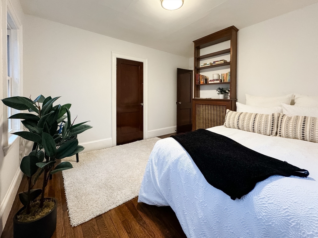 131 Damon Road Medford, MA 02155 - Photo 14 of 22 a bedroom with a bed lamp and a potted plant