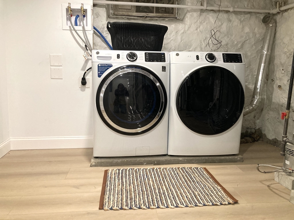 131 Damon Road Medford, MA 02155 - Photo 16 of 22 a view of a hallway with washer and dryer