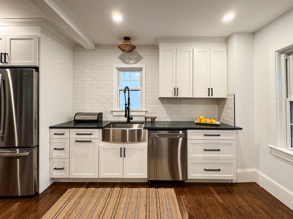 131 Damon Road Medford, MA 02155 - Photo 3 of 22 a kitchen with stainless steel appliances a stove a refrigerator and white cabinets