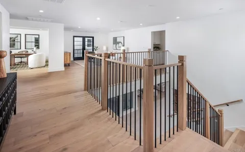 an entryway with wooden floor and dining room