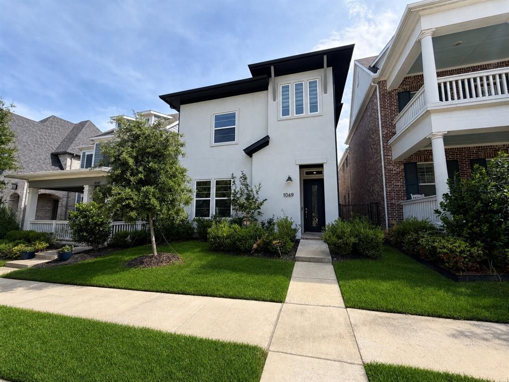 Modern stucco facade with black trim accents