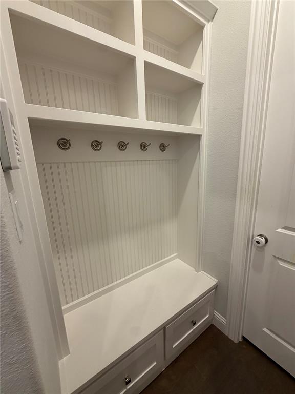 1049 Sarah Street Allen, TX 75013 - Photo 3 of 12 Built-in mudroom bench with two storage drawers, beadboard backing, five coat hooks, and upper cubby shelving
