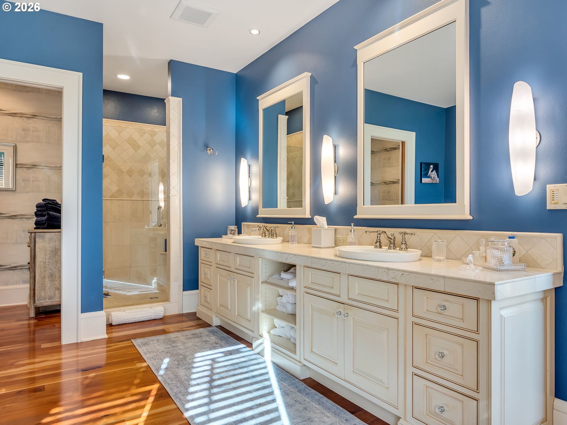 89079 Pinehurst Road Warrenton, OR 97146 - Photo 28 of 46 a bathroom with a double vanity sink a mirror and a shower