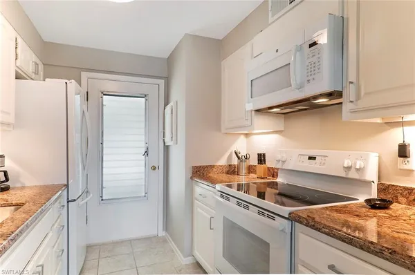 a kitchen with stainless steel appliances granite countertop a sink and a stove