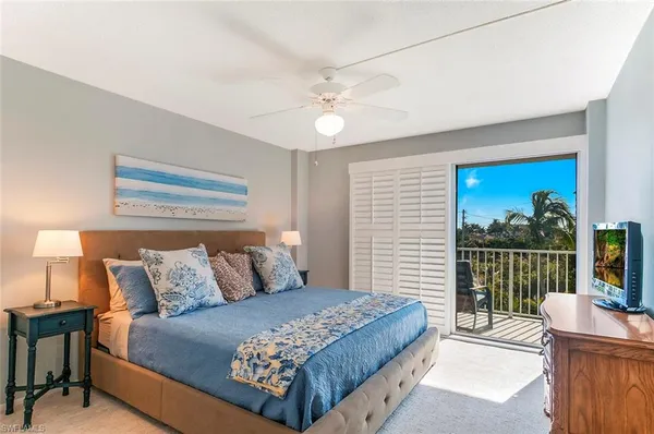 a bedroom with a large bed and a window