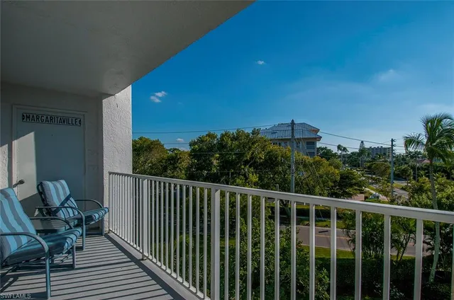 a balcony with wooden floor and outdoor space