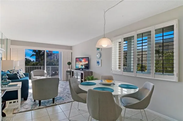 a living room with fireplace furniture and a large window