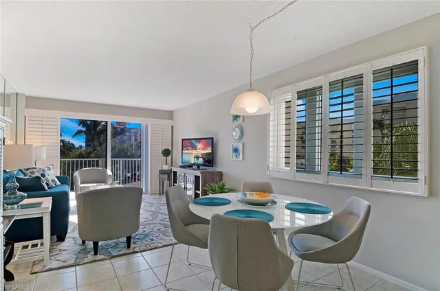 a living room with fireplace furniture and a large window