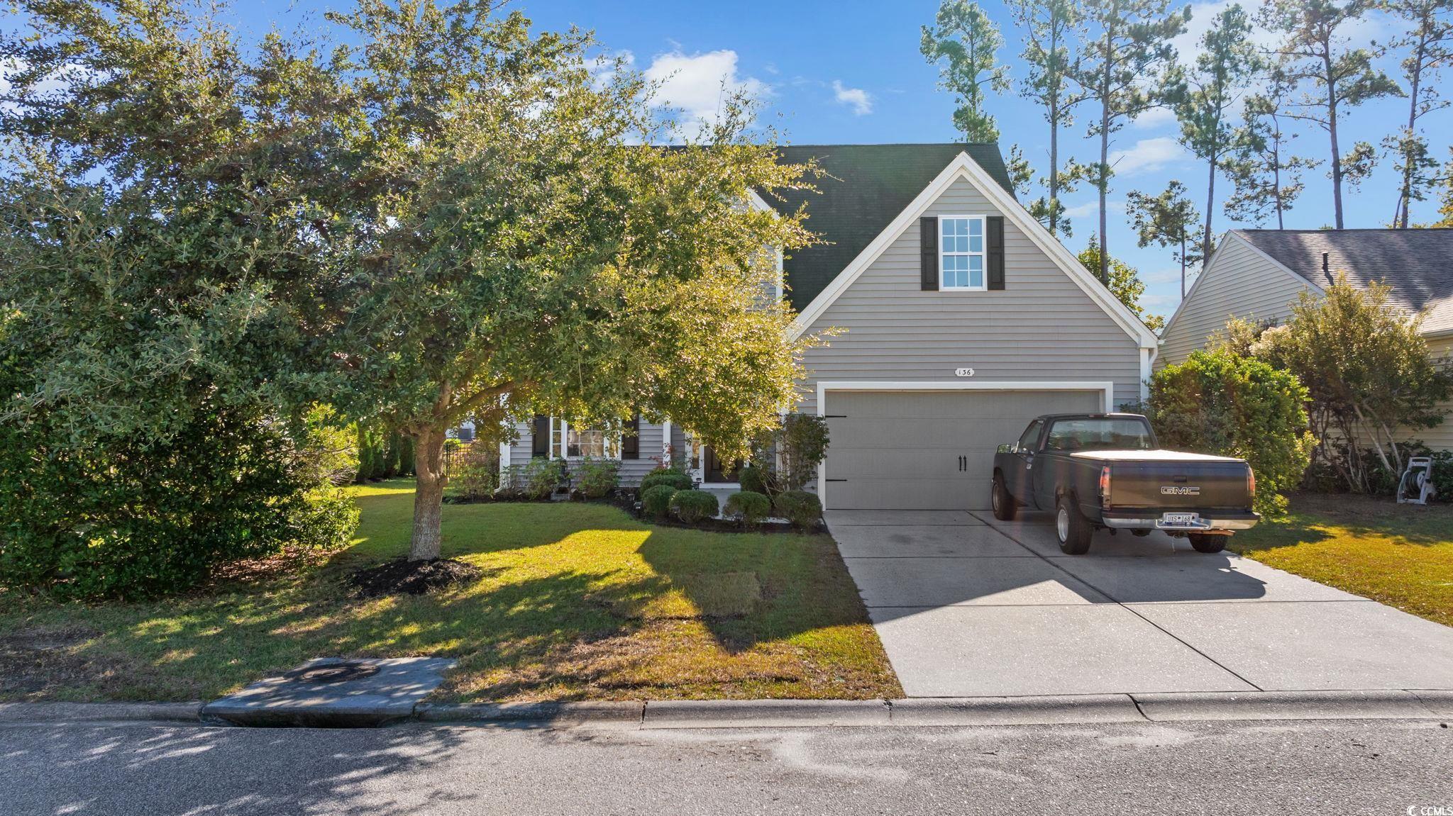 136 Carolina Oaks Drive Murrells Inlet, SC 29576 - Photo 1 of 40 View of front of home with a front lawn, concrete driveway, and an attached garage