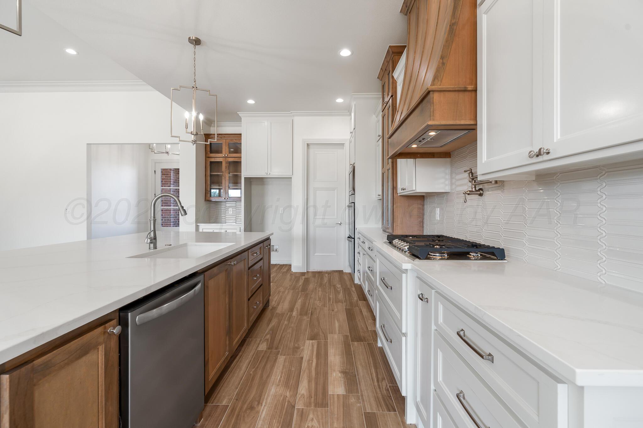 16551 Spring Lake Drive Canyon, TX 79015 - Photo 17 of 60 a kitchen with stainless steel appliances granite countertop a sink a stove and a refrigerator