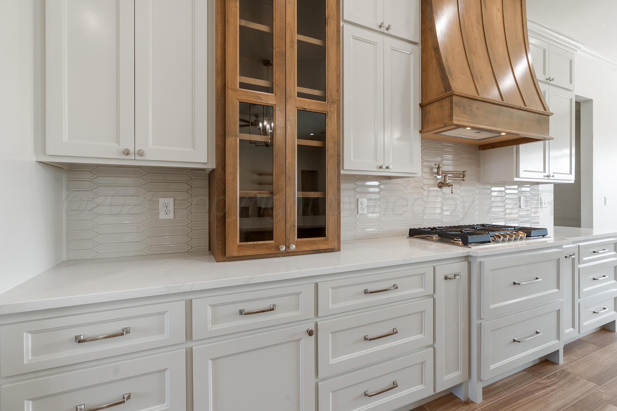 16551 Spring Lake Drive Canyon, TX 79015 - Photo 18 of 60 a kitchen with granite countertop white cabinets and white appliances